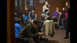 Relatives of missing passengers wait for the latest news inside a hotel room in Beijing on Wednesday, March 12.