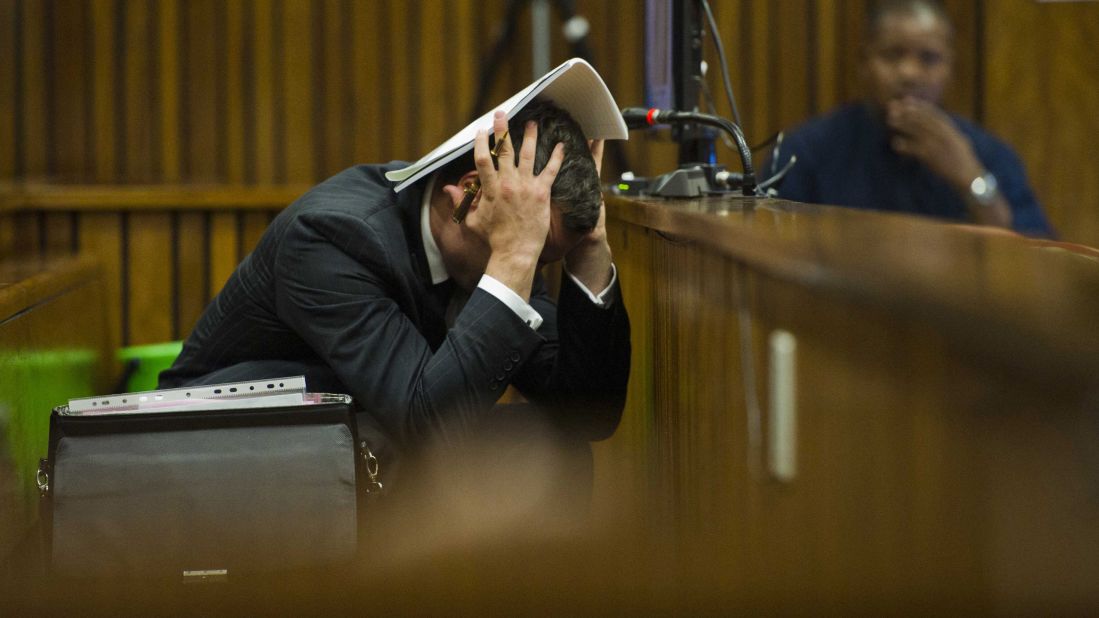 Pistorius covers his head as he listens to forensic evidence Thursday, March 13.