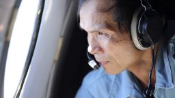 Vietnamese Air Force Col. Pham Minh Tuan watches out from a window on board a flying aircraft during a mission to search for the missing Malaysia Airlines flight MH370 in the Gulf of Thailand over the location where Chinese satellite images showed possible debris from the missing Malaysian jetliner, Thursday, March 13, 2014.