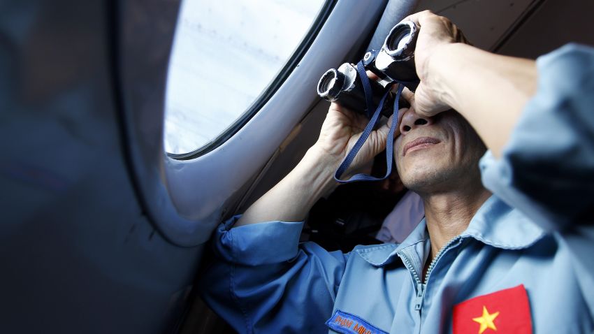 Image #: 28024720    epa04122659 A Vietnamese military official uses a binocular to look out a window inside a flying Soviet-made AN-26 of the Vietnam Air Force during search and rescue operations for a missing Malaysian Airlines flight, off Vietnam's sea, 13 March 2014. Vietnam fully resumed its search for the Malaysia Airlines plane that went missing, after communicating with Malaysian authorities over media reports, subsequently denied, regarding the plane's last known location. Malaysia Airlines flight MH370 with 239 people on board went missing early 08 March 2014 while on its way from Kuala Lumpur, Malaysia, to Beijing, China.  LUONG THAI LINH/EPA/LANDOV