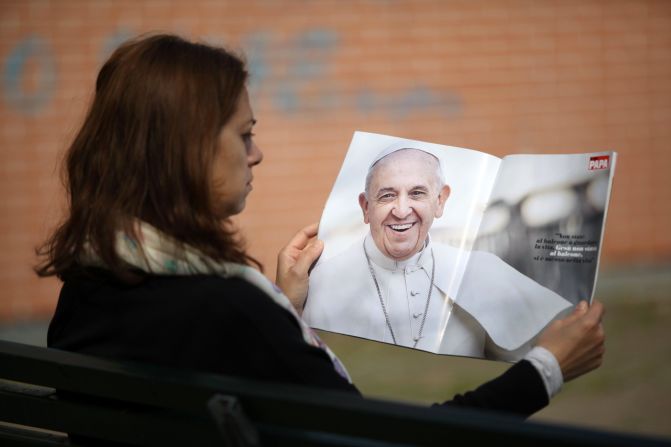 A woman in Milan, Italy, reads a copy of the magazine "Il Mio Papa," or "My Pope," on Tuesday, March 11. Pope Francis has enjoyed nearly <a href="http://www.cnn.com/2013/11/09/world/gallery/pope-francis/index.html">unprecedented popularity since his election</a> last year.