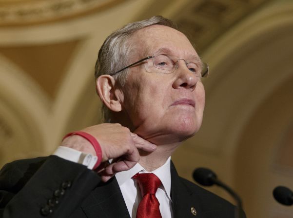 Senate Majority Leader Harry Reid makes a cutting gesture across his neck Tuesday, March 11, referencing California Rep. Darrell Issa, who <a href="http://politicalticker.blogs.cnn.com/2014/03/06/issa-tries-to-clear-the-air-with-rep-cummings-2/">caused an uproar last week</a> when he cut the microphone of his Democratic counterpart on the Oversight and Government Reform Committee.