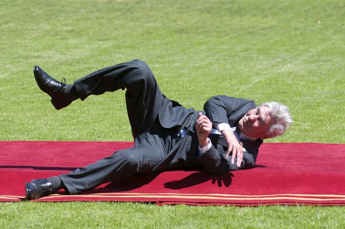Former Dutch Prime Minister Ruud Lubbers falls after tripping on the red carpet Tuesday, March 11, at the presidential palace in Vina del Mar, Chile. He was one of many dignitaries attending the swearing-in ceremony for Chilean President Michelle Bachelet.