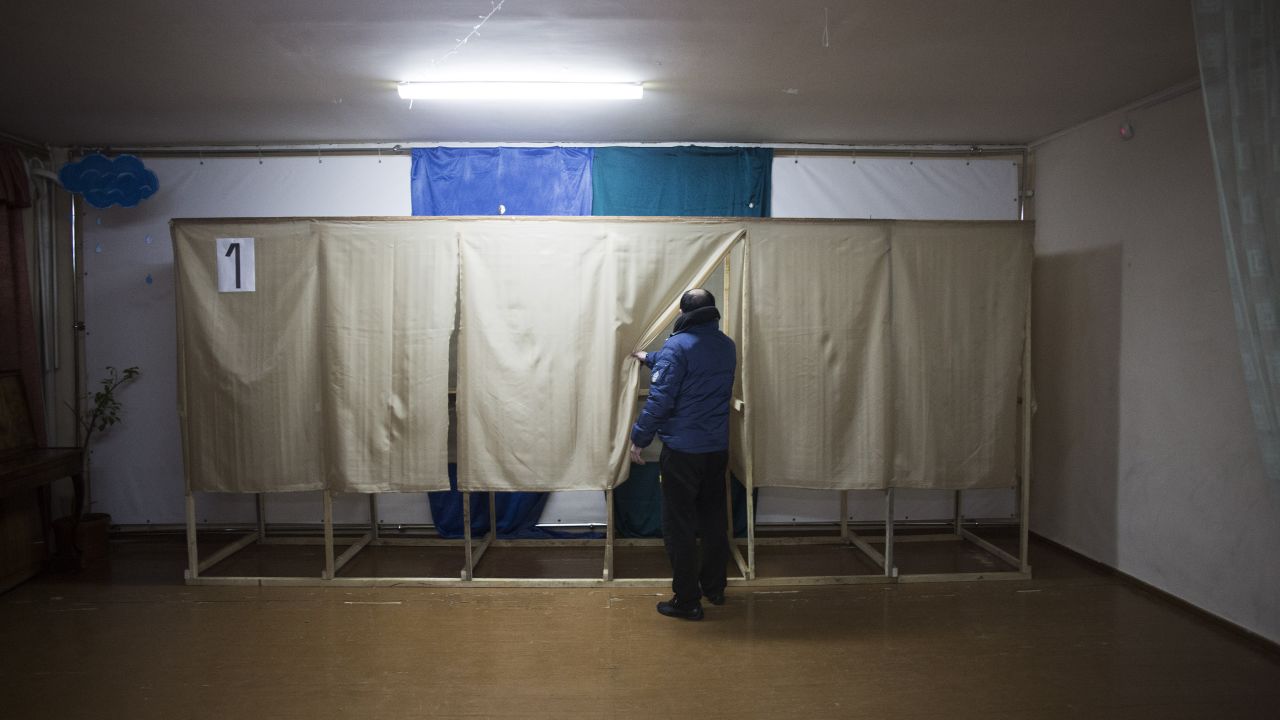 A member of a pro-Russian self-defense unit checks a polling station near Simferopol on March 13.