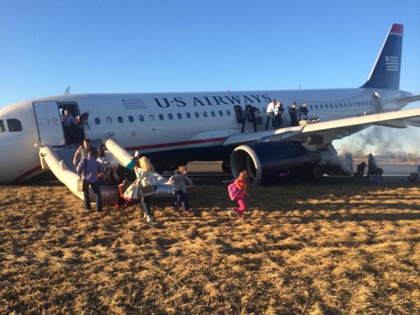 Passengers evacuate US Airways Flight 1702 on Thursday, March 13, after <a href="http://www.cnn.com/2014/03/13/us/philadelphia-airport-incident/index.html">the jet's takeoff was aborted</a> in Philadelphia. A tire on the plane's front landing gear blew out. <a href="http://www.cnn.com/2014/03/07/world/gallery/week-in-photos-0307/index.html">See last week in 32 photos.</a>