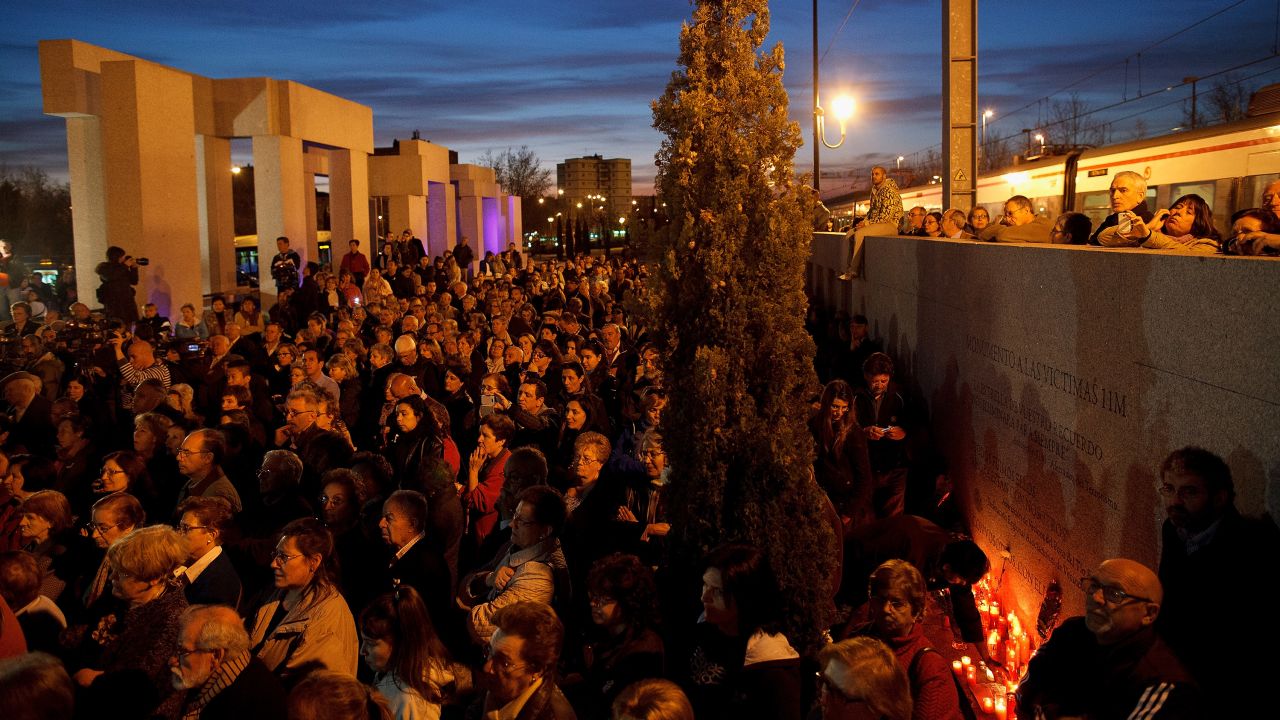 People gather during a memorial for the victims of Madrid train bombings outside El Pozo train station during the 10th anniversary on March 11, 2014 in Madrid, Spain.
