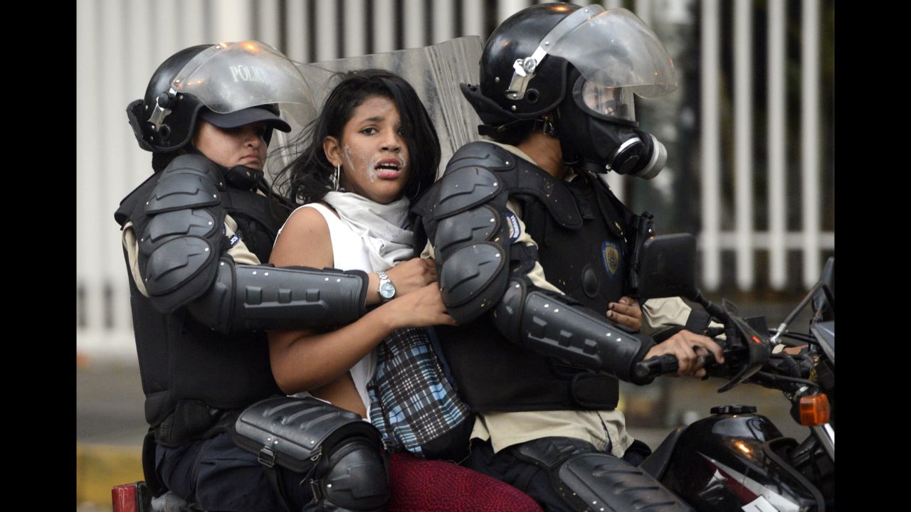 An activist is taken by police during an anti-government protest in Caracas on March 13.