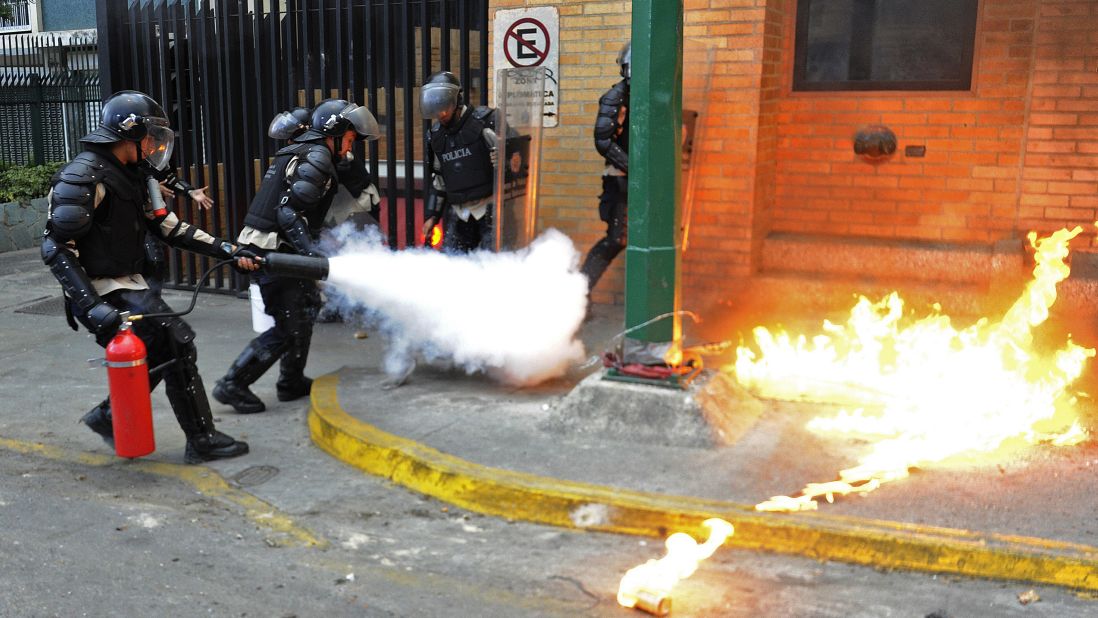 Police officers put out a Molotov cocktail on March 13.