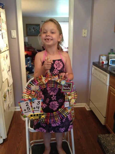 Katherine Linzey's 6-year-old daughter, Elyse, poses with a crayon wreath made as an end-of-year gift for her kindergarten teacher last year.