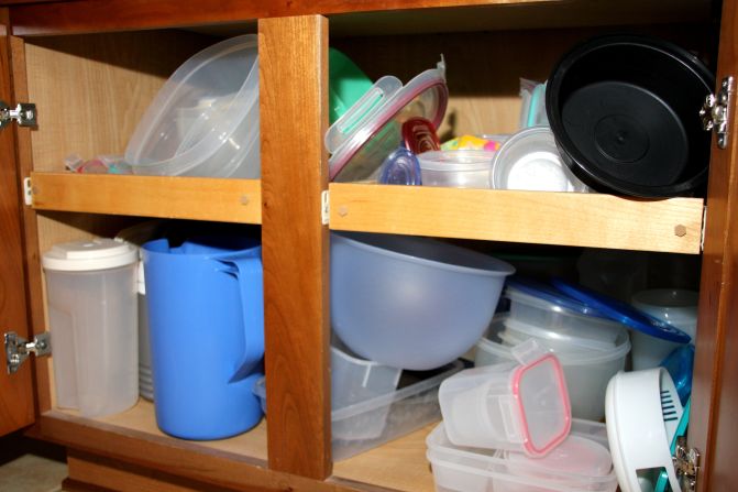 Brockett's Tupperware cabinet: "There is a reason that I have doors on my cabinets. You're safe unless you open them. With the doors closed I don't have to look at this mess. Unless, of course, I need to store something."