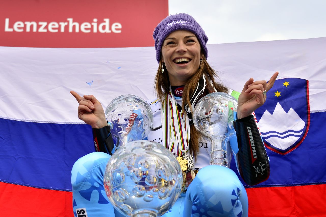 Tina Maze, the overall women's World Cup champion of 2013, poses with her three Crystal globe trophies. They are awarded to the winners of each skiing discipline.