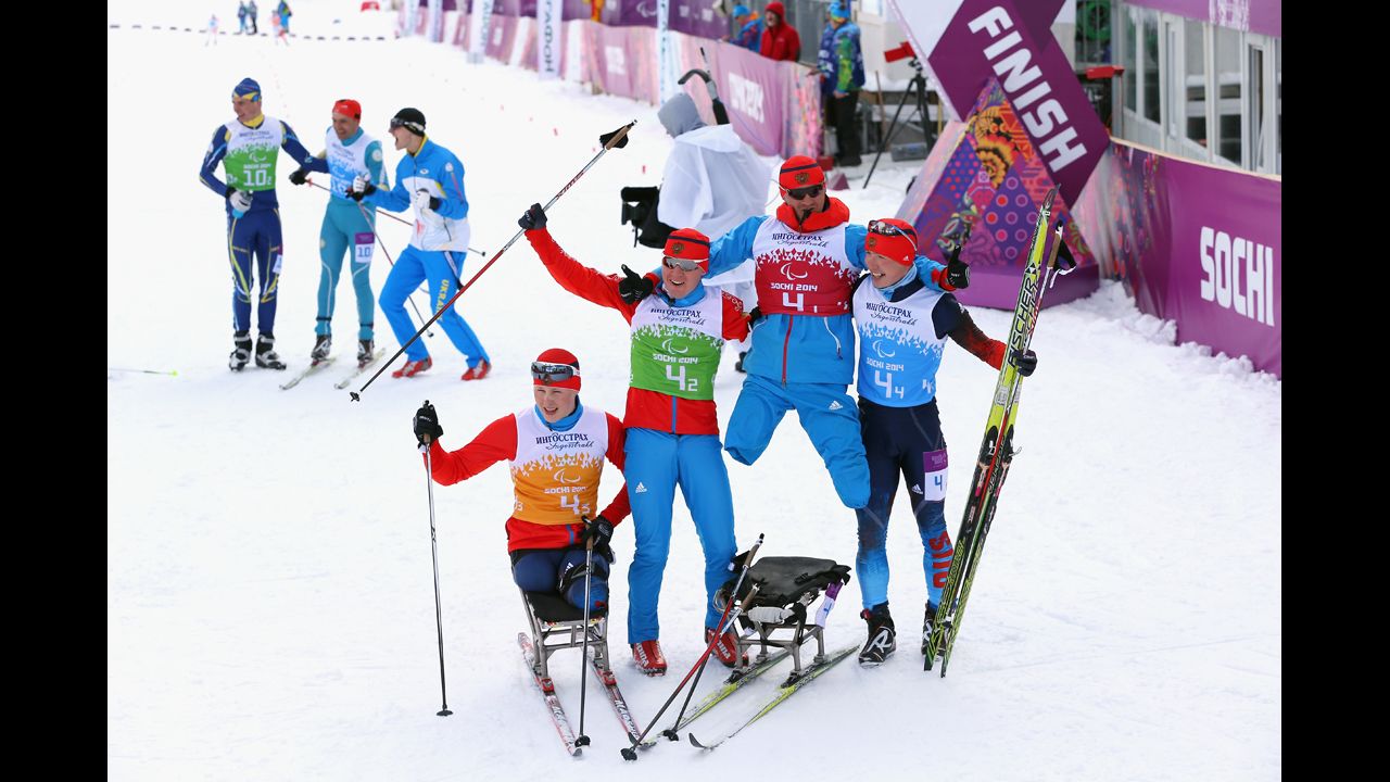 Grigory Murygin, left, Vladislav Lekomtcev, Roman Petushkov and Rushan Minnegulov of Russia celebrate after winning the 4 x 2.5-kilometer open relay cross-country skiing event on March 15.