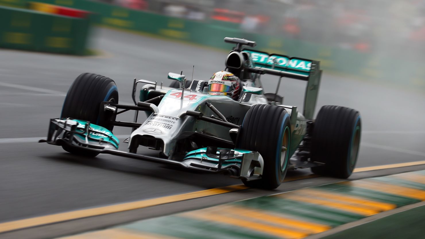 Mercedes driver Lewis Hamilton followed up his hot practice form by qualifying fastest in the wet conditions at Albert Park.