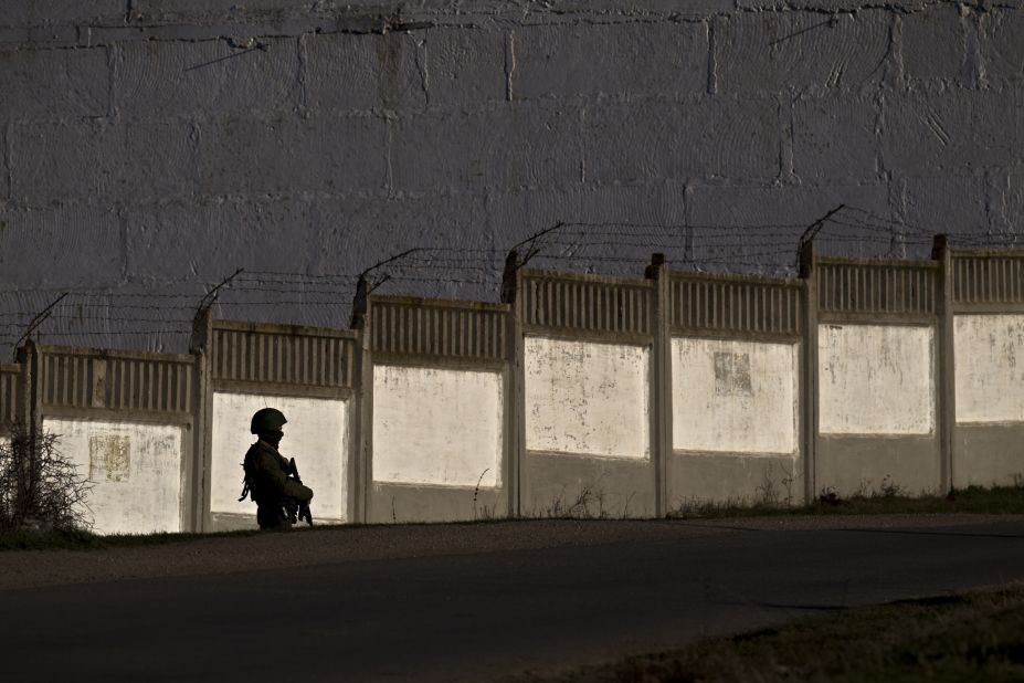 A pro-Russian soldier guards the perimeter outside an Ukrainian military base in Perevalne on March 15.