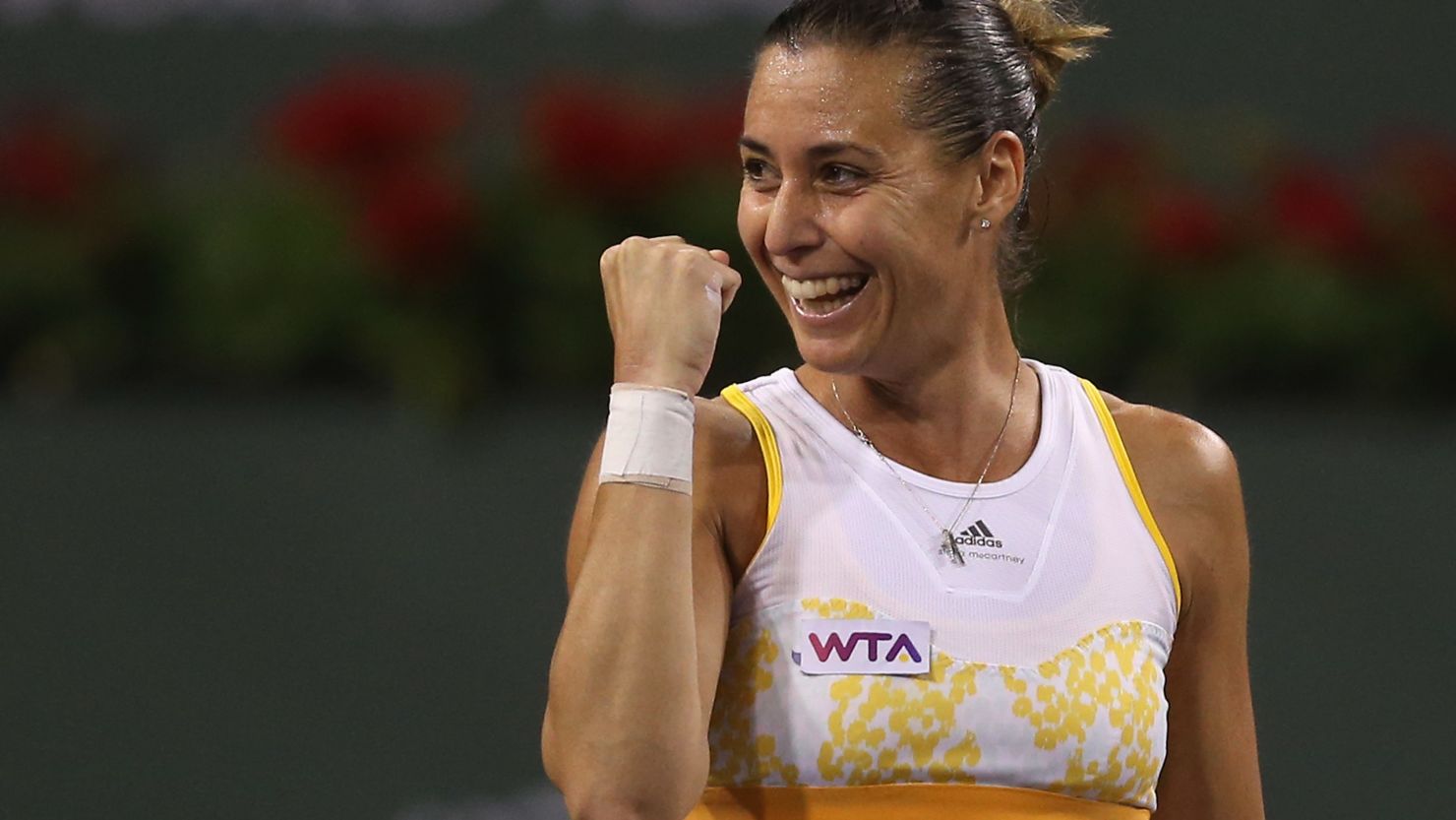 Italian tennis player Flavia Pennetta celebrates her victory over China's world No. 2 Li Na at Indian Wells Tennis Garden.