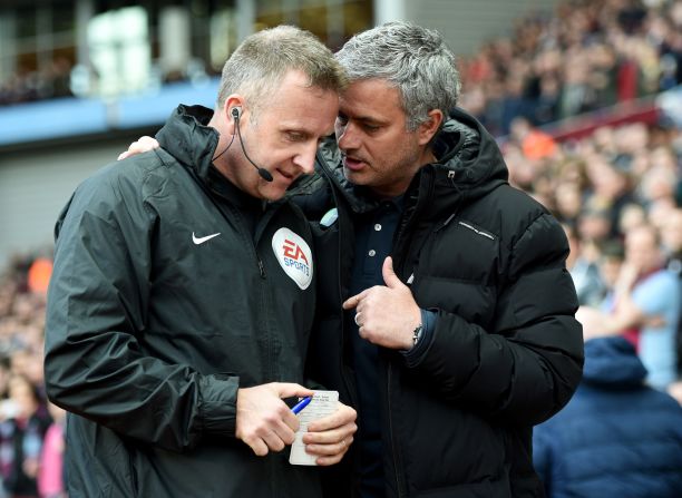 Mourinho talks to fourth official Jonathan Moss prior to the match at Villa Park.