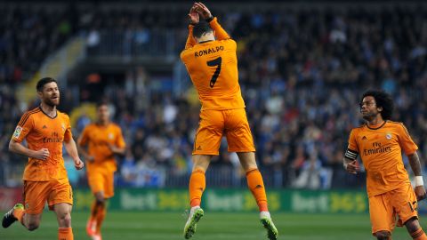 Cristiano Ronaldo leaps in celebration after scoring the only goal in Real Madrid's win at Malaga's Rosaleda stadium.