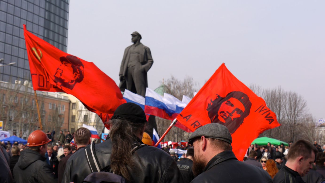 DONETSK, UKRAINE:  Demonstrators wave revolutionary flags at a major pro-Russia rally in Lenin Square in central Donetsk (March 15). Some are calling for independence from Ukraine. Others are calling for union with Russia.  Photo by CNN's Kellie Morgan.  