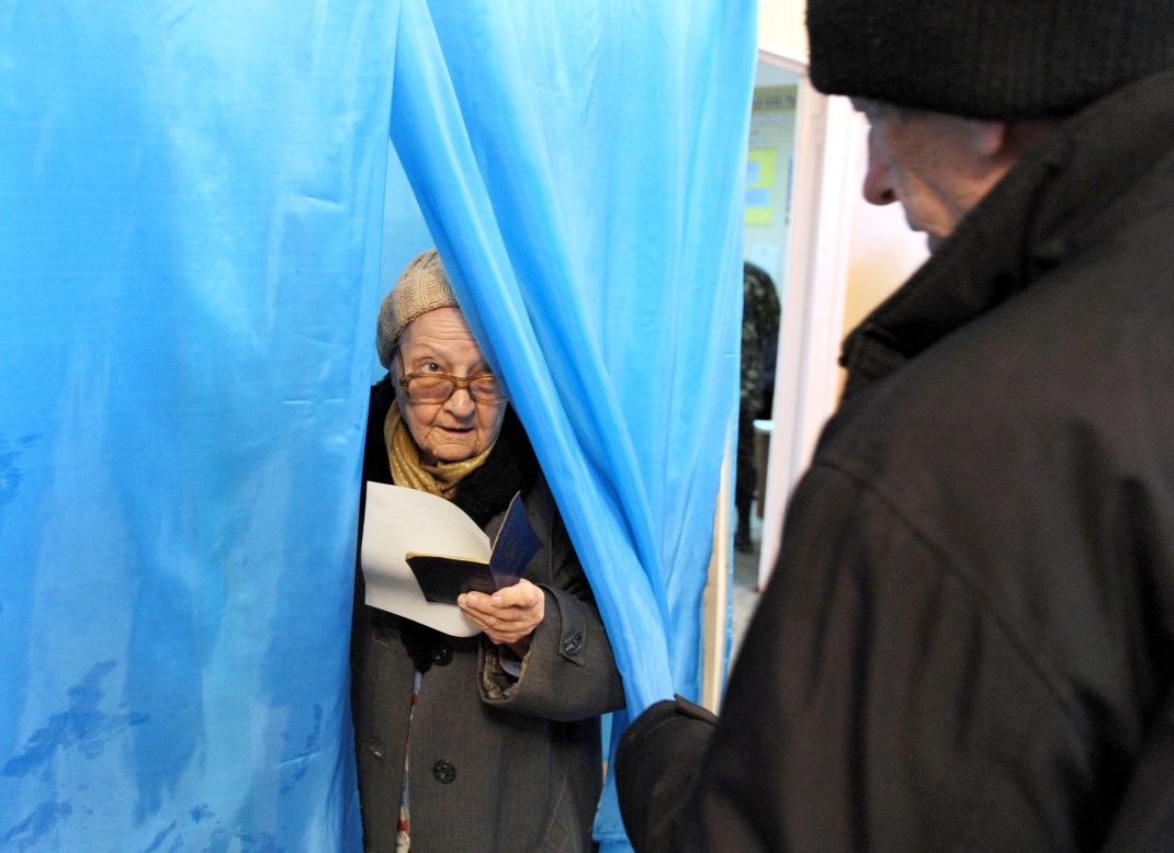 A woman leaves a voting booth in Sevastopol, Ukraine, on Sunday, March 16.  Polls opened Sunday morning in a referendum in Ukraine's Crimea region, in which voters are to voice their wish to either join Russia or become an effectively independent state connected to Ukraine.