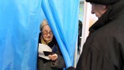 An eldery woman holds her ballot as she leaves a voting booth in one of the polling stations in Sevastopol on March 16, 2014. People in Crimea took to the polls on March 16 for a referendum on breaking away from Ukraine to join Russia that has precipitated a Cold War-style security crisis on Europe's eastern frontier. AFP PHOTO/ VIKTOR DRACHEV        (Photo credit should read VIKTOR DRACHEV/AFP/Getty Images)