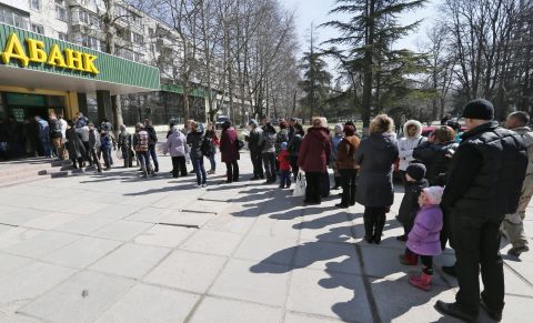 People stand in line to vote at a bank office in Simferopol, Ukraine. Results are expected on Monday. The United States has already said it expects the Black Sea peninsula's majority ethnic Russian population to vote in favor of joining Russia.