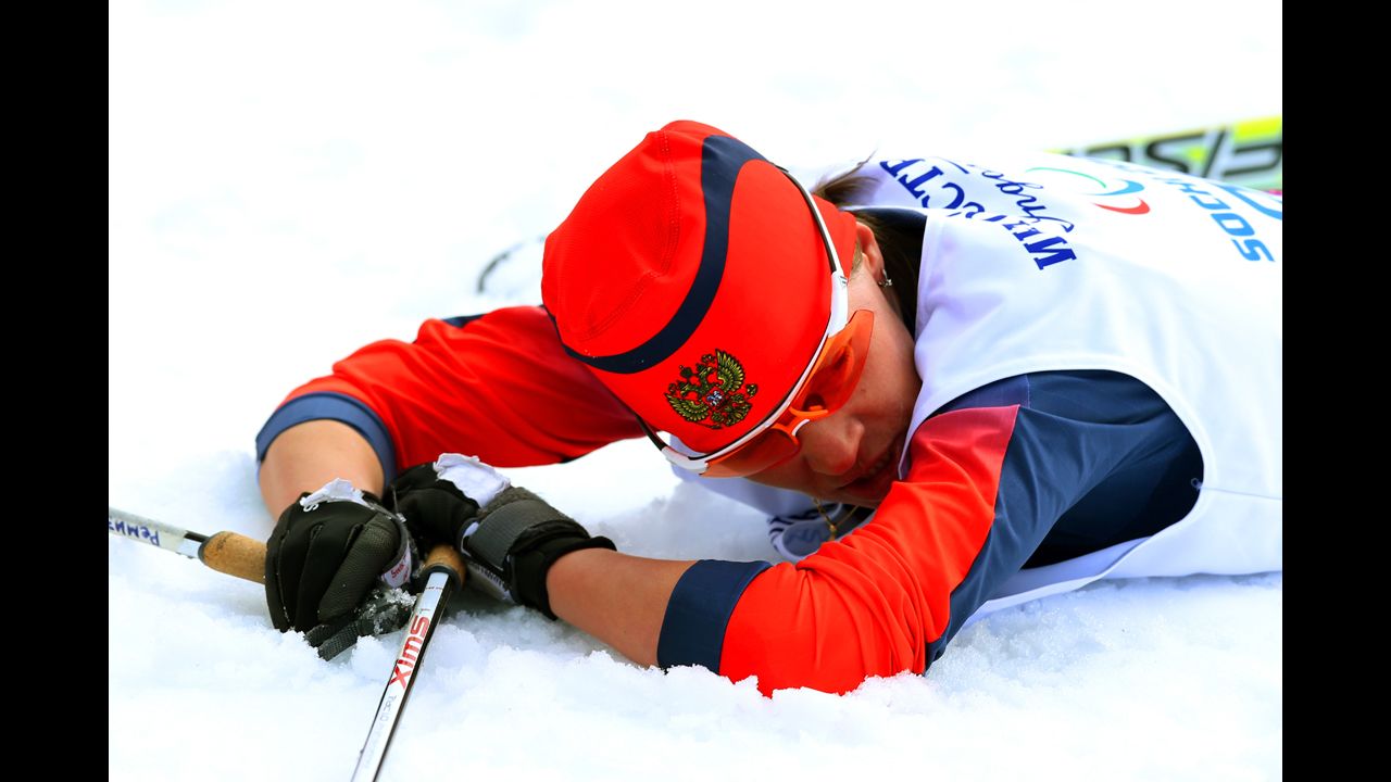 Gold medalist Elena Remizova of Russia collapses after crossing the finish line in the women's cross-country 5-kilometer free visually impaired event.