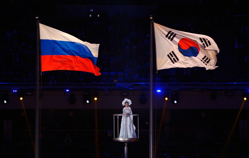 The Russian and South Korean flags fly as a performer sings. South Korea will host the 2018 Paralympic Winter Games.