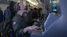 In this photo provided by the U.S. Navy, crew members on board an aircraft P-8A Poseidon assist in search and rescue operations for Malaysia Airlines flight MH370 in the Indian Ocean on Sunday, March 16, 2014. Malaysian authorities on Sunday examined a flight simulator that was confiscated from the home of one of the missing jetliner's pilots. The Boeing 777 went missing less than an hour into a March 8, flight from Kuala Lumpur to Beijing as it entered Vietnamese airspace.