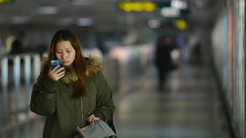 A woman uses her smartphone in a Shanghai metro station. Chinese mobile platforms are growing in popularity.