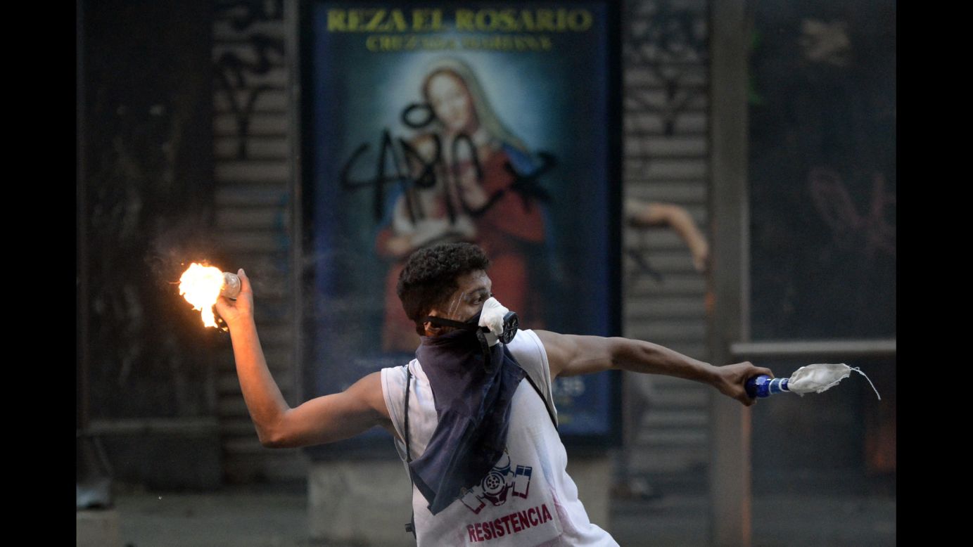 A demonstrator clashes with government forces during a protest in Caracas on Saturday, March 15.
