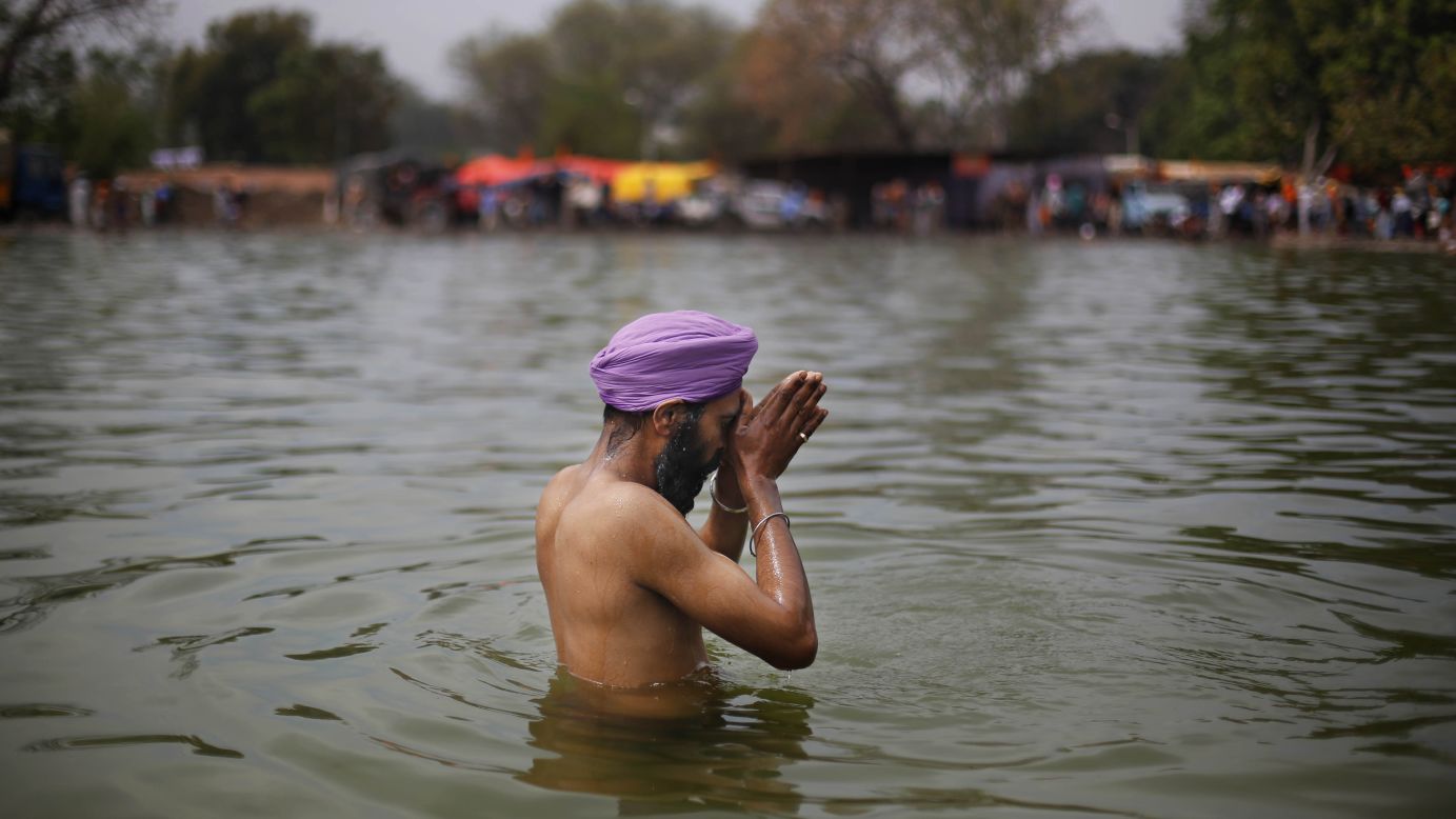 A man prays as he washes himself before a religious procession in Punjab, India, on March 17.