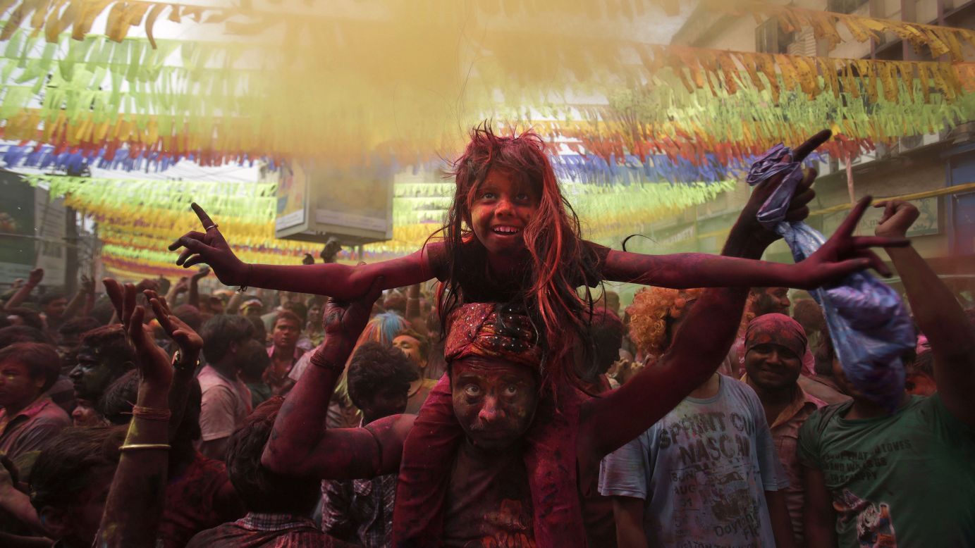 A girl sits on her father's shoulders during celebrations in Gauhati on March 17.