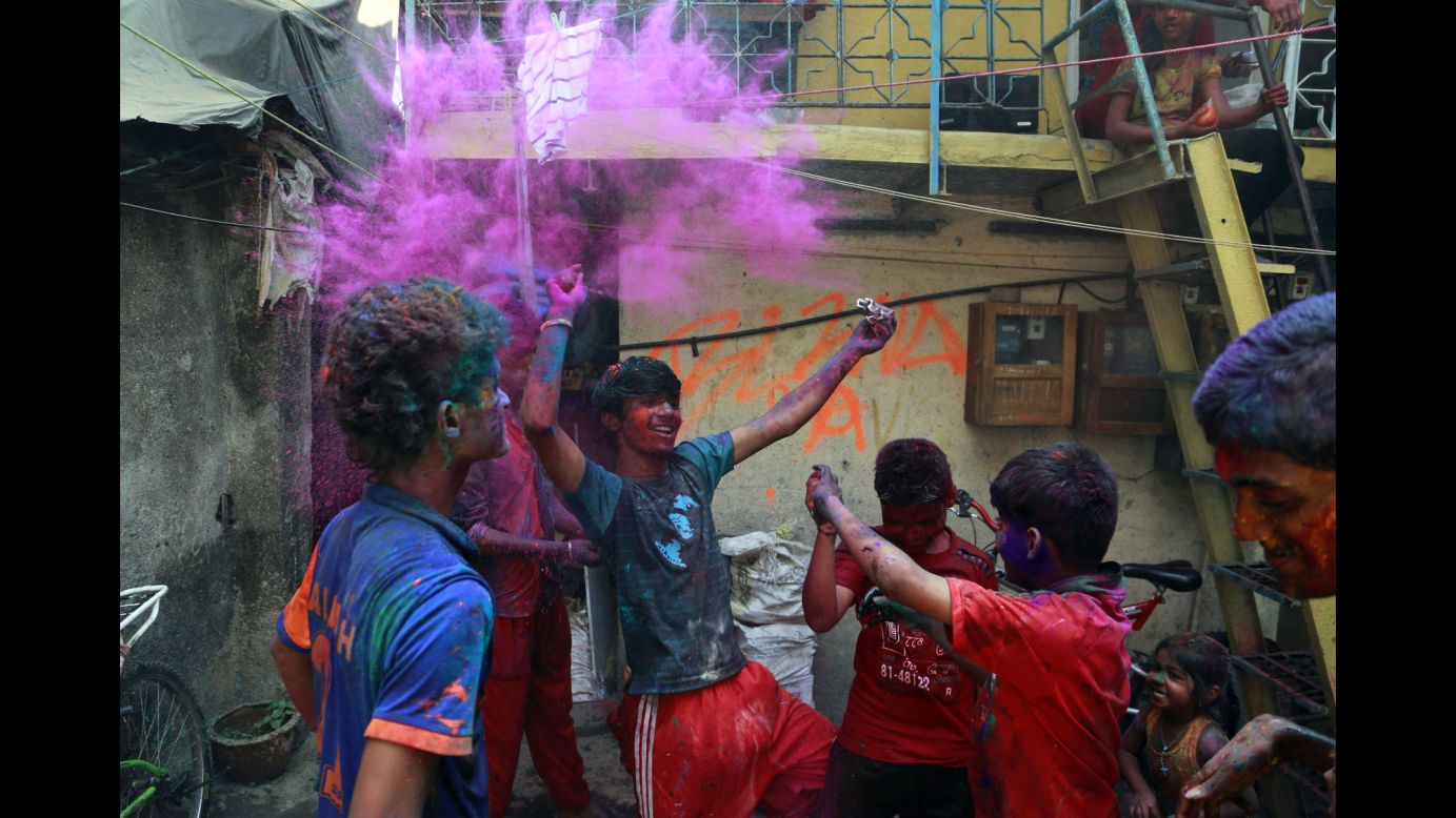 Children play with colored powder in Mumbai on March 17.