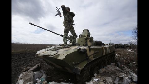 A Ukrainian soldier stands on top of an armored vehicle at a military camp near the village of Michurino, Ukraine, on March 17.