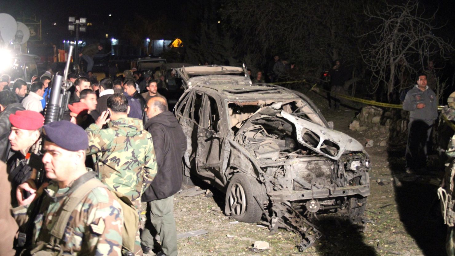 Lebanese security forces inspect the site of a suicide car bomb attack near Nabi Uthman on March 16, 2014.