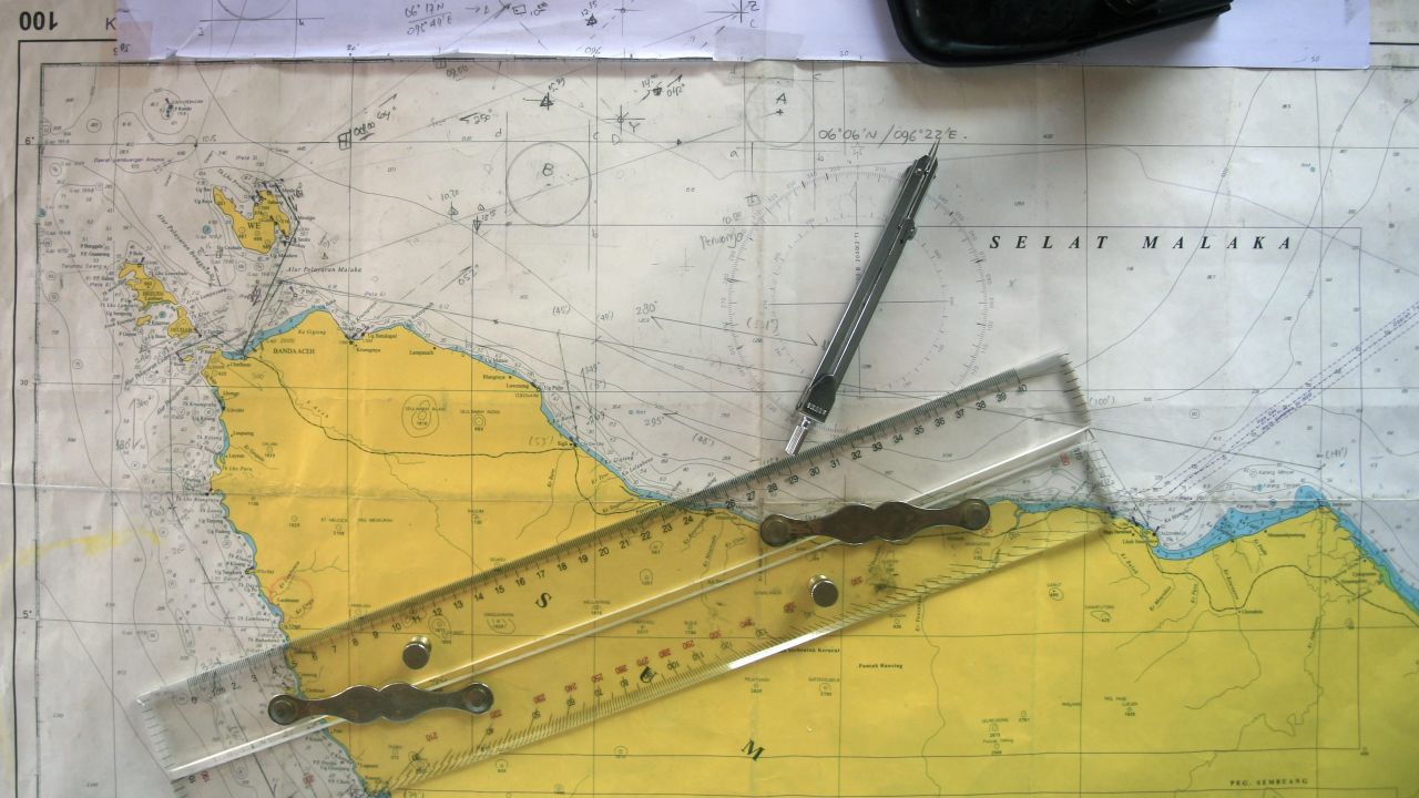 Image #: 28081585 epa04125995 Indonesian Search And Rescue (SAR) personnel observe a map showing the Indian Ocean an Malacca straits during a search operation for the missing Malaysian Airlines plane flight MH370, in the Indian Ocean, near the tip of Sumatra Island, Indonesia, 15 March 2014. The missing Malaysian aircraft's communication system was likely disabled while still in the country's airspace, Malaysian Prime Minister Najib Razak said on 15 March. Razak also said the plane had changed its flight path, and now appears likely to have gone westward. Malaysia Airlines flight MH370 with 239 people on board went missing early 08 March 2014 while on its way from Kuala Lumpur to Beijing. HOTLI SIMANJUNTAK/EPA/LANDOV