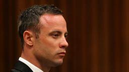 South African Paralympic athlete Oscar Pistorius sits in the dock during his trial for the murder of his girlfriend Reeva Steenkamp, at the North Gauteng High Court in Pretoria, on March 17, 2014. Pistorius is on trial for murdering his girlfriend Reeva Steenkamp at his suburban Pretoria home on Valentine's Day last year. He says he mistook her for an intruder. AFP PHOTO/POOL/Siphiwe Sibeko (Photo credit should read SIPHIWE SIBEKO/AFP/Getty Images)