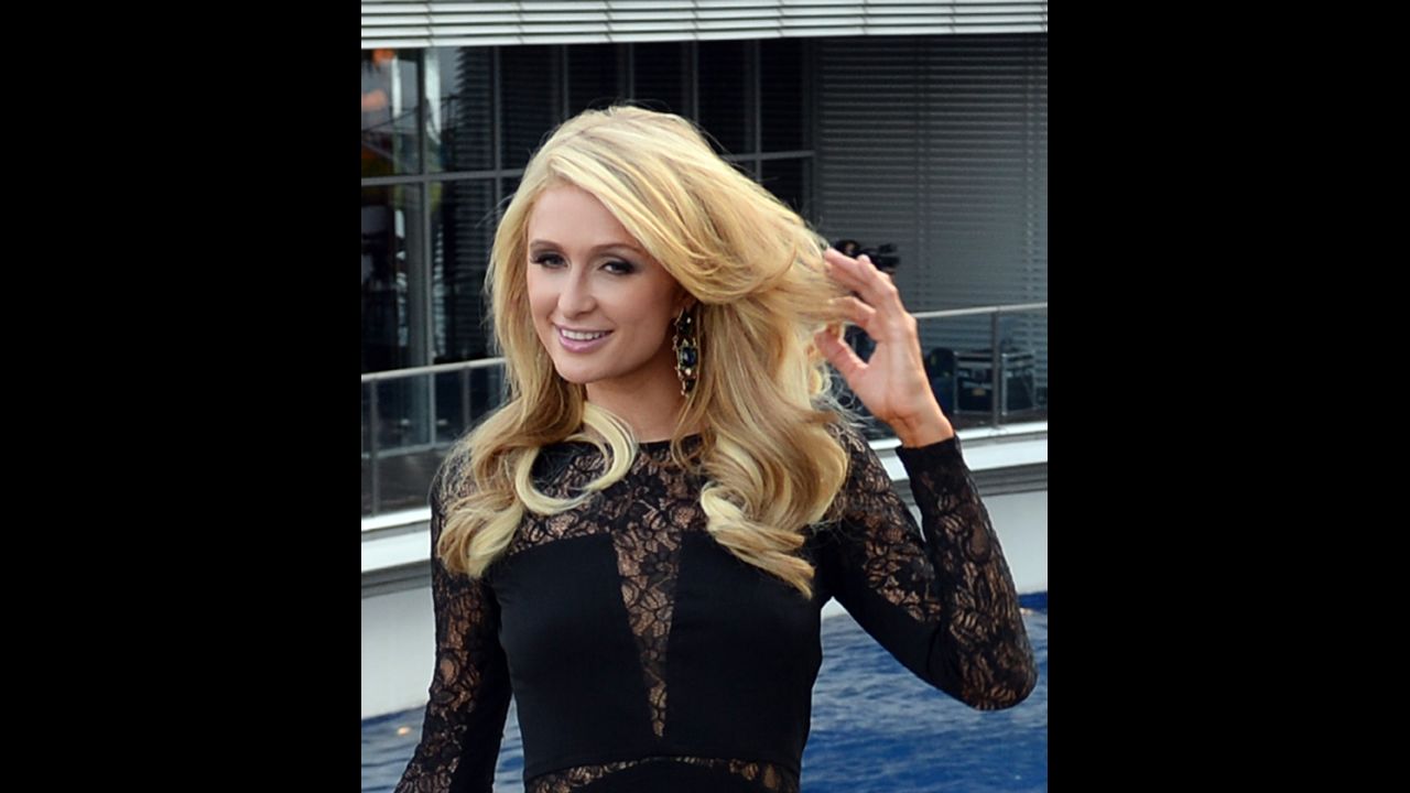 US socialite and entertainer Paris Hilton poses for photographers during the inauguration of her first real estate project, the Paris Beach Club, in Manila on March 13, 2014. 