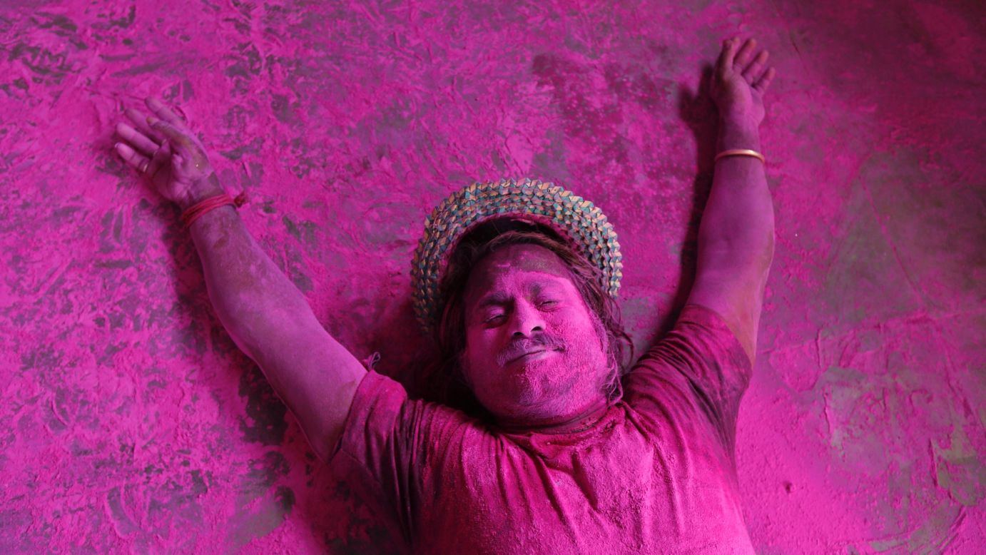 A man lies on the ground smeared in colored powder during Holi celebrations in Allahabad, India, on Monday, March 17. The Holi festival of colors is a Hindu celebration of the arrival of spring. It is celebrated mainly in India and Nepal.