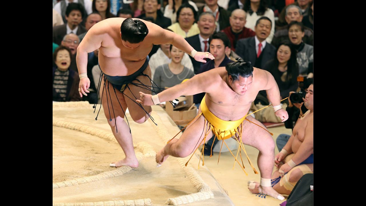 Goeido, left, pushes Shohozan out of the ring Wednesday, March 12, at the Grand Sumo Tournament in Osaka, Japan.