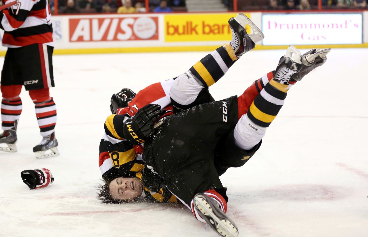 Mack Lemmon of the Kingston Frontenacs falls to the ice after being tackled by Troy Henley of the Ottawa 67's during a fight in their Ontario Hockey League game Tuesday, March 11, in Ottawa.