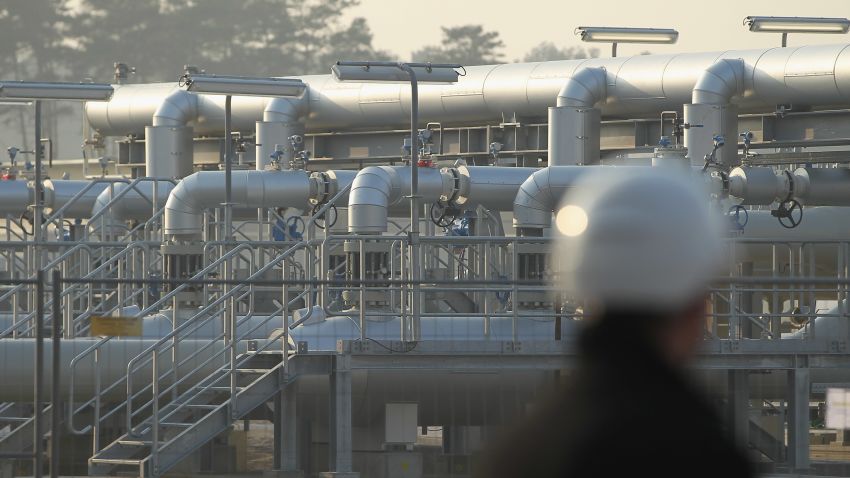 A man wearing a hard hat looks out at the central facility where the Nord Stream Baltic Sea gas pipeline reaches western Europe following the pipeline's official inauguration on November 8, 2011 in Lubmin, Germany.