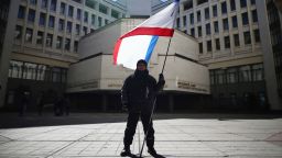 A man holds a Crimean flag in front of the Crimean parliament building on March 17, 2014 in Simferopol, Ukraine. People in Crimea overwhelmingly voted to secede from Ukraine during a referendum vote on March 16 and the Crimean Parliament has declared Independence and formally asked Russia to annex them