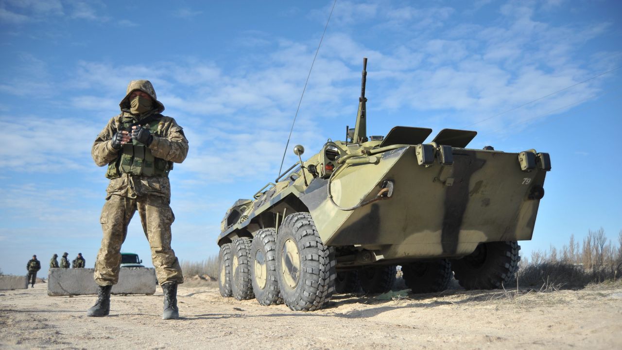 Ukrainian soldiers stand guard at a checkpoint near Strilkove, Ukraine, close to Crimea on Monday, March 17.