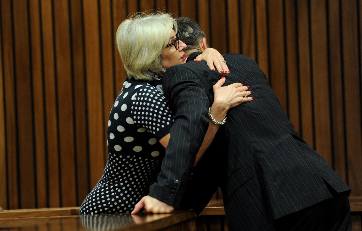 Pistorius is hugged by his aunt Lois on March 18.