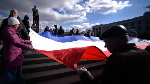 Demonstrators hold a Crimean flag at Lenin Square in Simferopol on March 18.