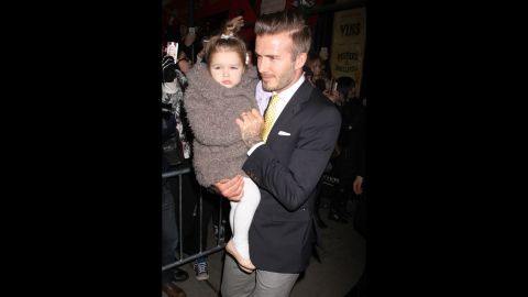 Beckham and his daughter, Harper, make their way through a crowd in New York in February. Harper, Beckham's fourth child, was born in 2011. 