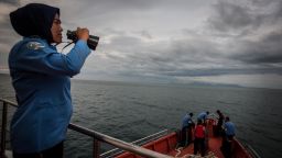 A personnel of Indonesia's National Search and Rescue looks over horizon during a search in the Andaman sea area around northern tip of Indonesia's Sumatra island for the missing Malaysian Airlines flight MH370 on March 17, 2014.