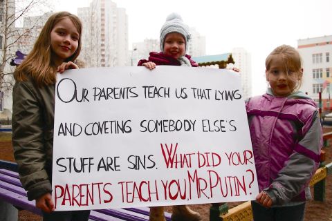 Ukrainian children in Kiev show off a sign they made in response to the Crimea referendum.