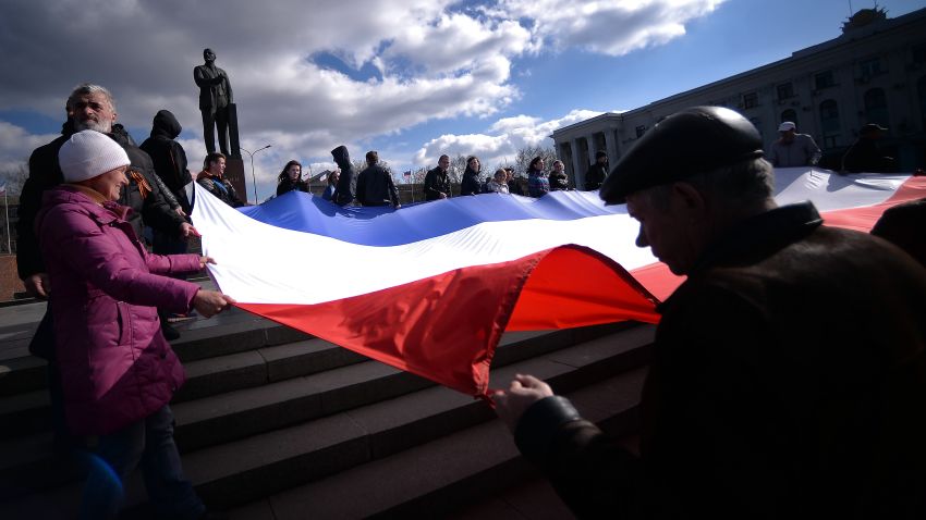 Demonstrators hold a Crimean flag at Lenin's square in central Simferopol on March 18, 2014.